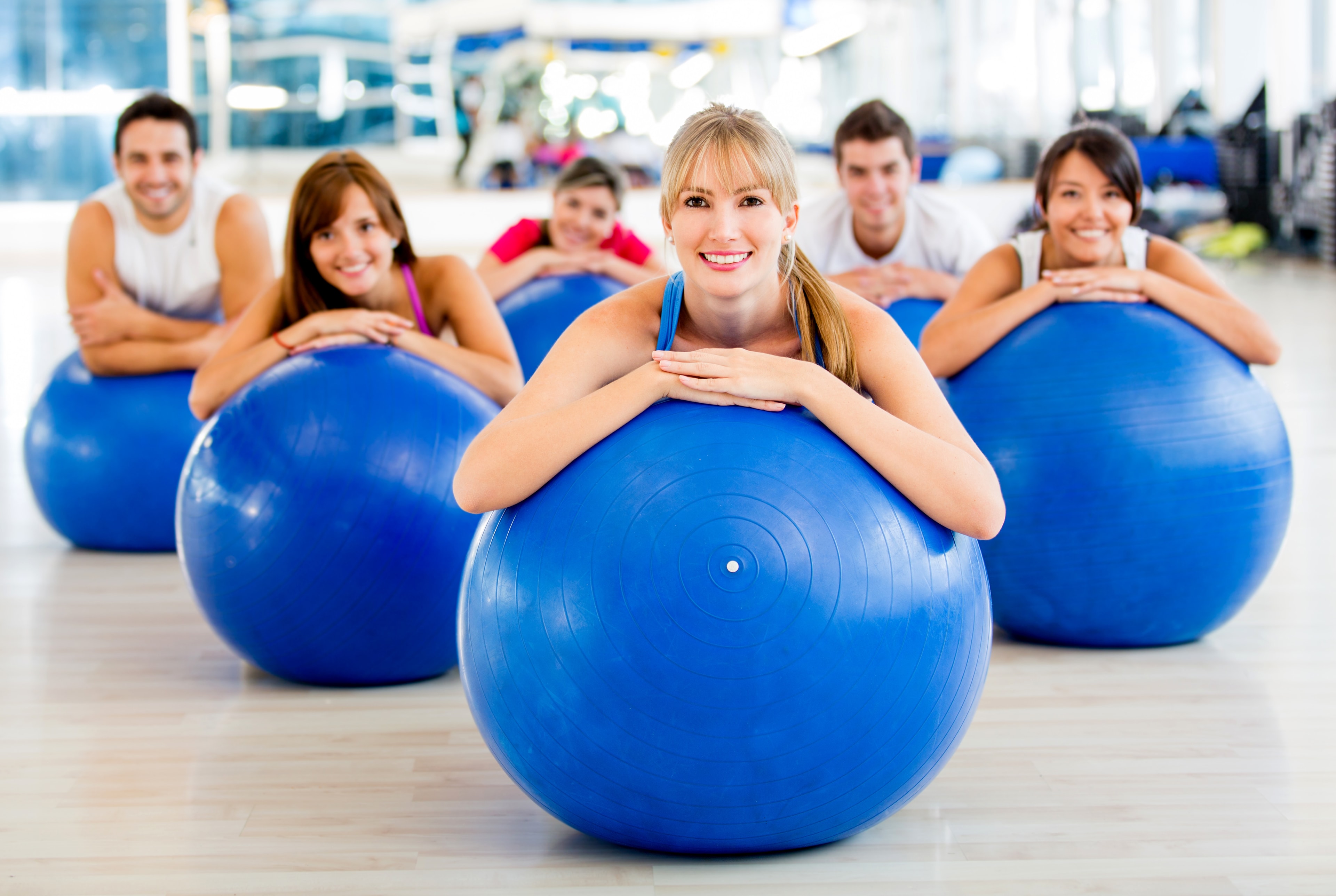 Group of women and men smiling together beyond the workout